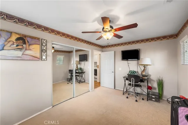 a view of a livingroom with furniture and a ceiling fan