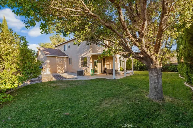 a front view of a house with yard patio and green space