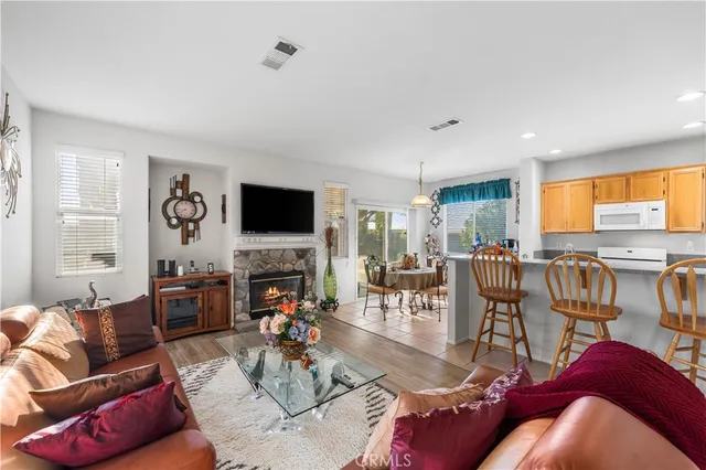 a living room with furniture flat screen tv and a large window