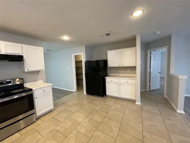 a kitchen with a cabinets and steel stainless steel appliances