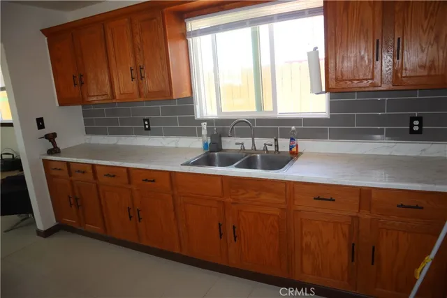 a kitchen with stainless steel appliances granite countertop wooden cabinets a sink and dishwasher