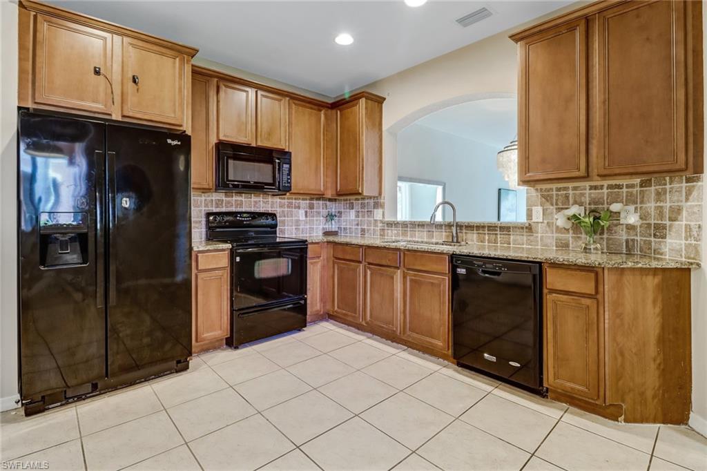 17536 Cherry Ridge Lane Fort Myers, FL 33967 - Photo 11 of 26 a kitchen with stainless steel appliances granite countertop a refrigerator and a stove top oven