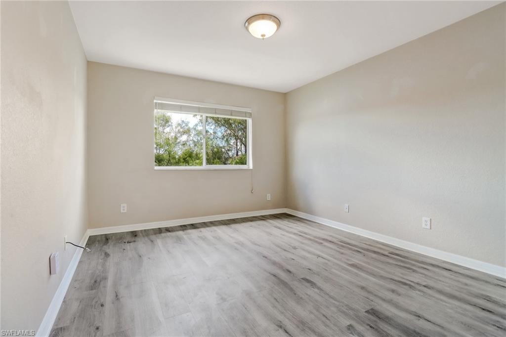 17536 Cherry Ridge Lane Fort Myers, FL 33967 - Photo 12 of 26 an empty room with wooden floor and windows