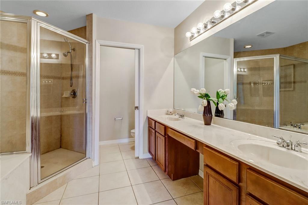 17536 Cherry Ridge Lane Fort Myers, FL 33967 - Photo 16 of 26 a bathroom with a granite countertop sink mirror and shower