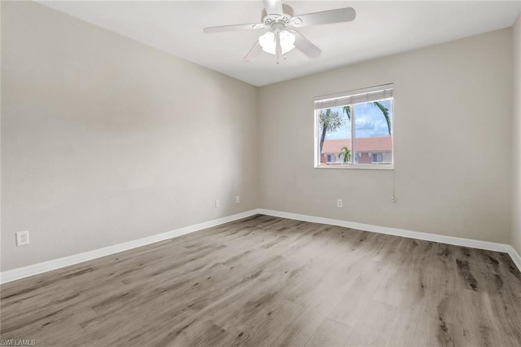 17536 Cherry Ridge Lane Fort Myers, FL 33967 - Photo 18 of 26 a view of an empty room with wooden floor and a window