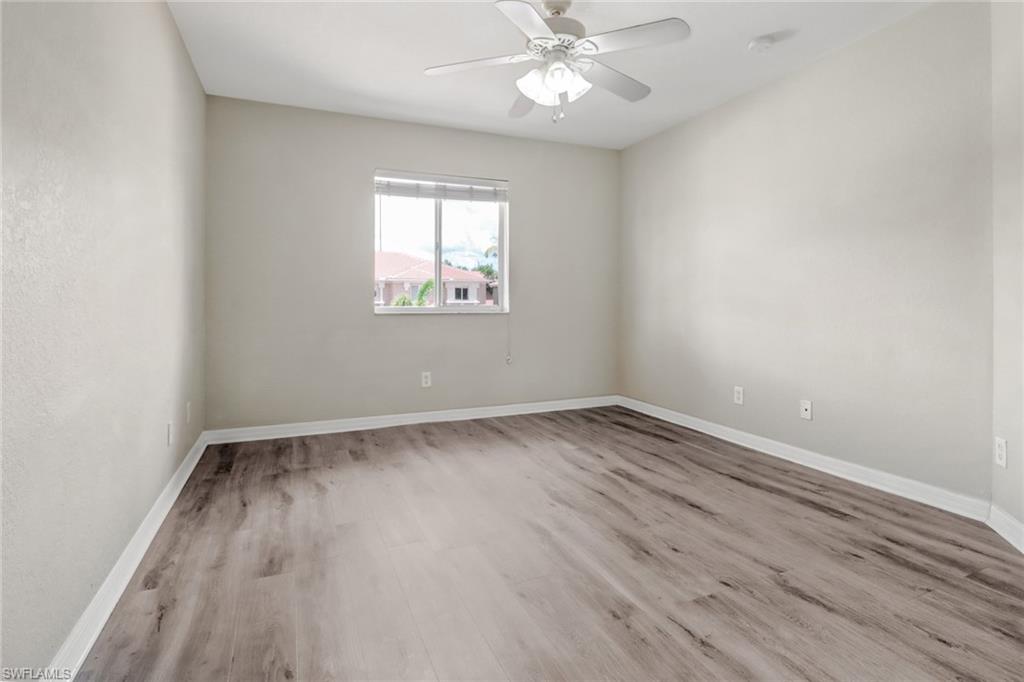 17536 Cherry Ridge Lane Fort Myers, FL 33967 - Photo 19 of 26 an empty room with wooden floor and windows