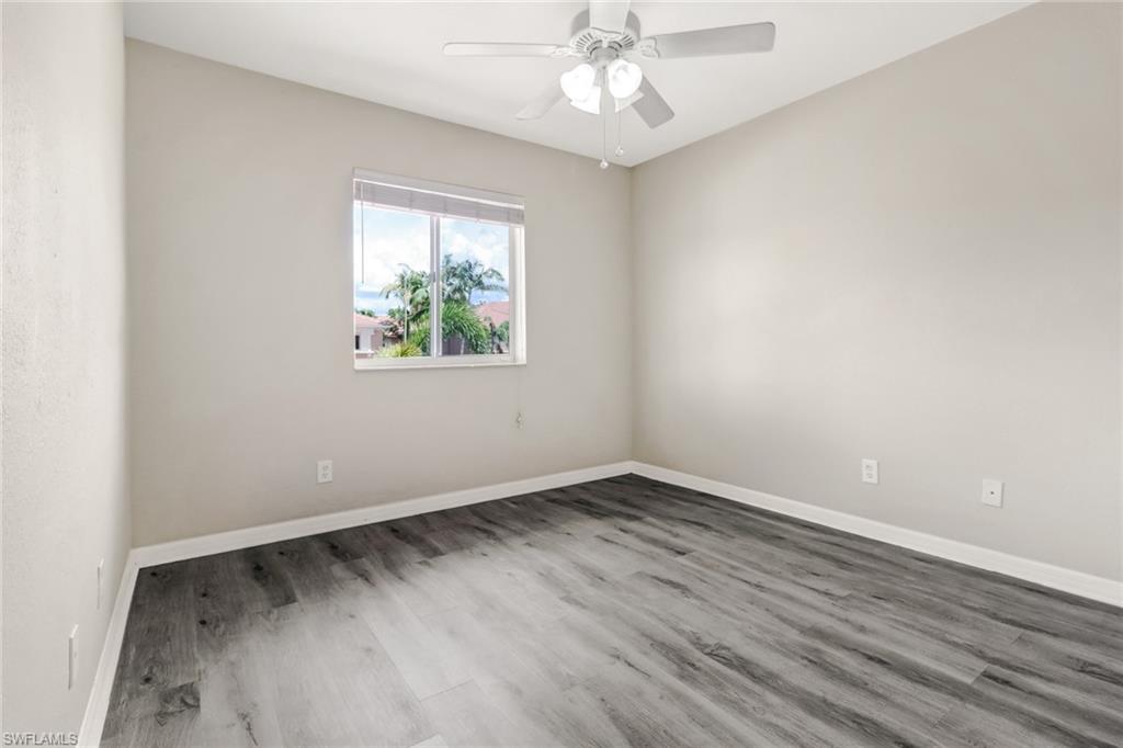 17536 Cherry Ridge Lane Fort Myers, FL 33967 - Photo 21 of 26 an empty room with wooden floor and windows