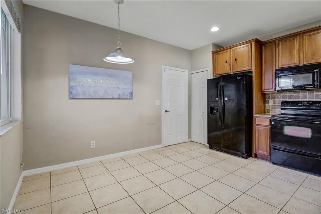 17536 Cherry Ridge Lane Fort Myers, FL 33967 - Photo 8 of 26 a kitchen with stainless steel appliances a refrigerator and a stove top oven