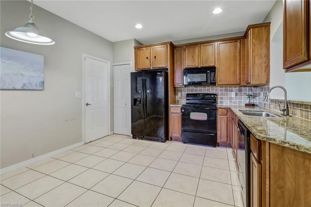 17536 Cherry Ridge Lane Fort Myers, FL 33967 - Photo 9 of 26 a kitchen with stainless steel appliances granite countertop a refrigerator stove and sink