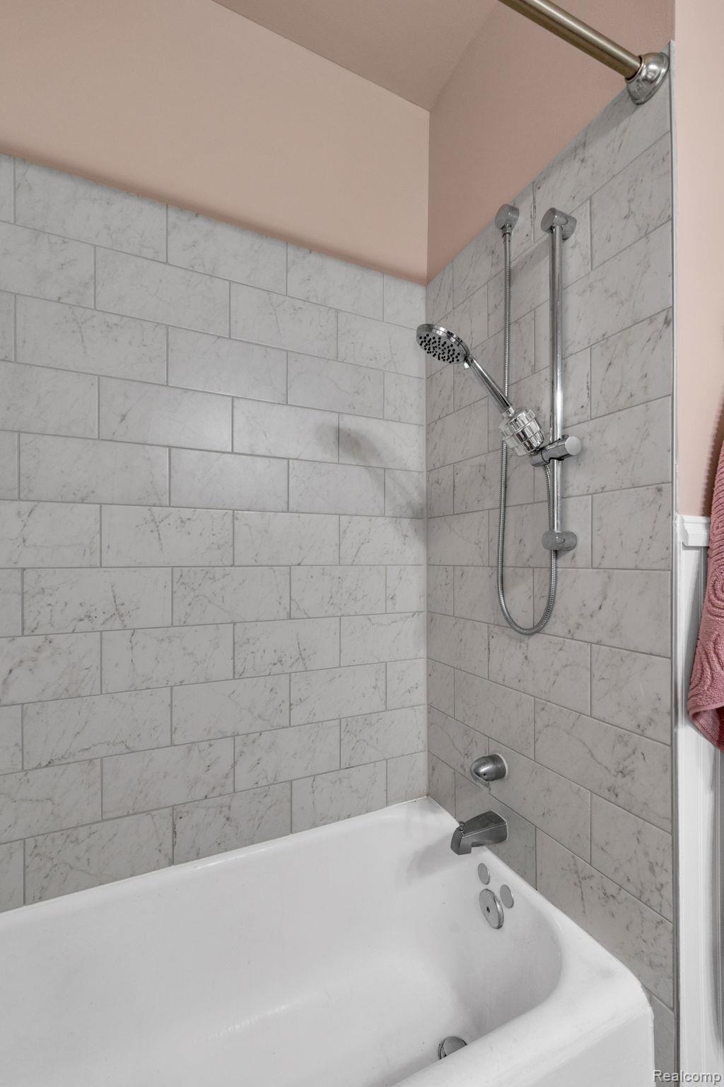 7631 Maple Street Dearborn, MI 48126 - Photo 24 of 48 Tub/shower combination featuring subway tile surround, polished chrome fixtures, and a shower curtain rod