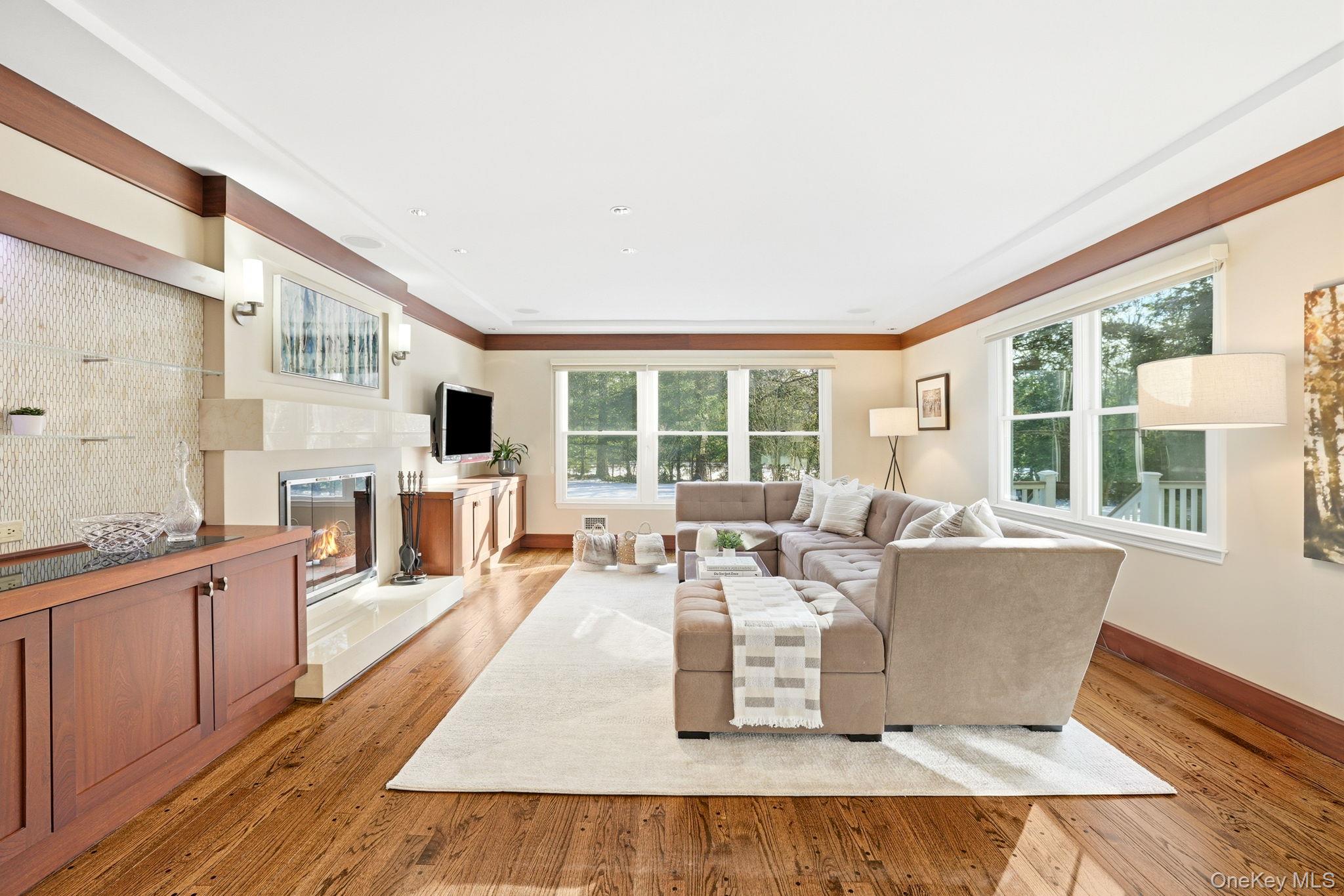 42 Butler Road Scarsdale, NY 10583 - Photo 8 of 35 Expansive family room with fireplace and built-ins