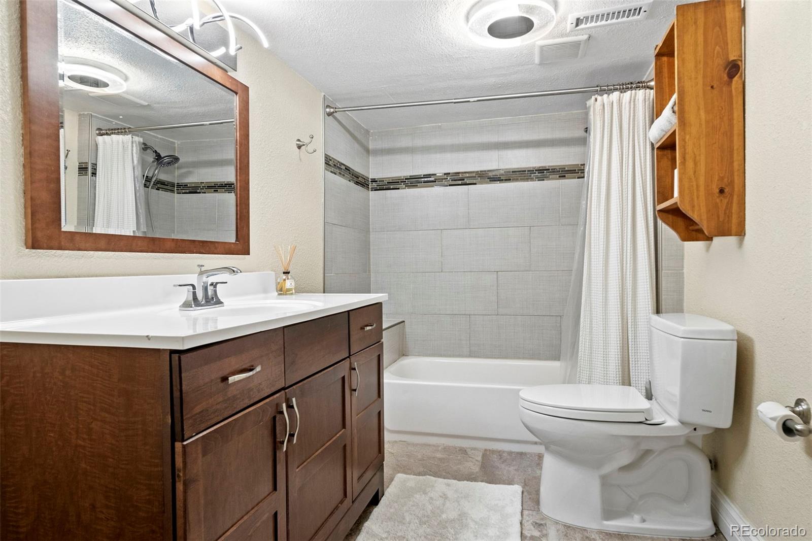 4319 Raritan Street Denver, CO 80211 - Photo 17 of 27 a bathroom with a sink a toilet and shower