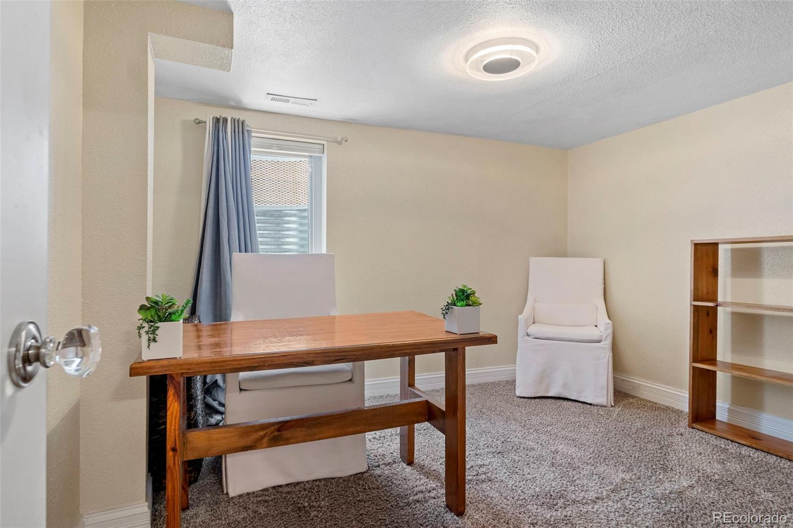4319 Raritan Street Denver, CO 80211 - Photo 19 of 27 a living room with furniture and a potted plant