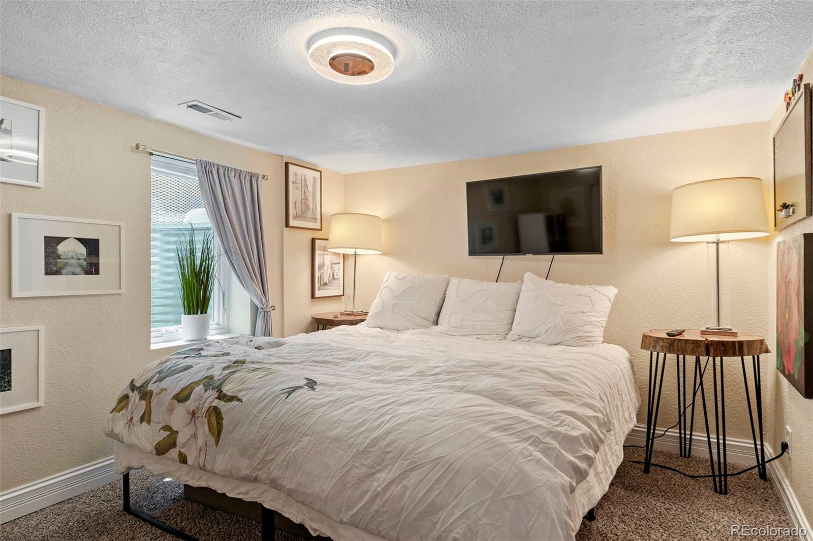 4319 Raritan Street Denver, CO 80211 - Photo 20 of 27 a bedroom with a bed and a flat screen tv