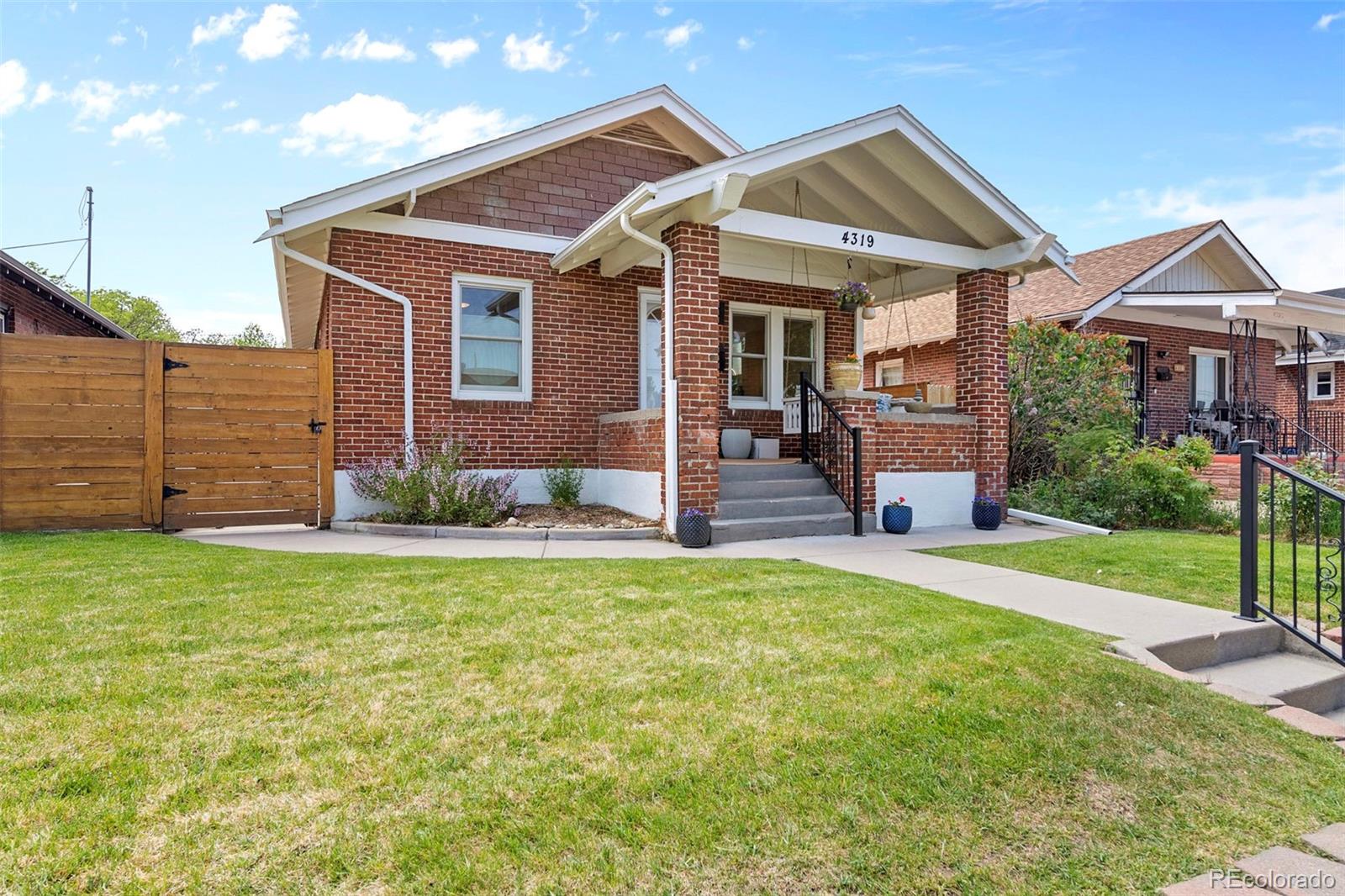 4319 Raritan Street Denver, CO 80211 - Photo 2 of 27 a front view of a house with a garden and yard