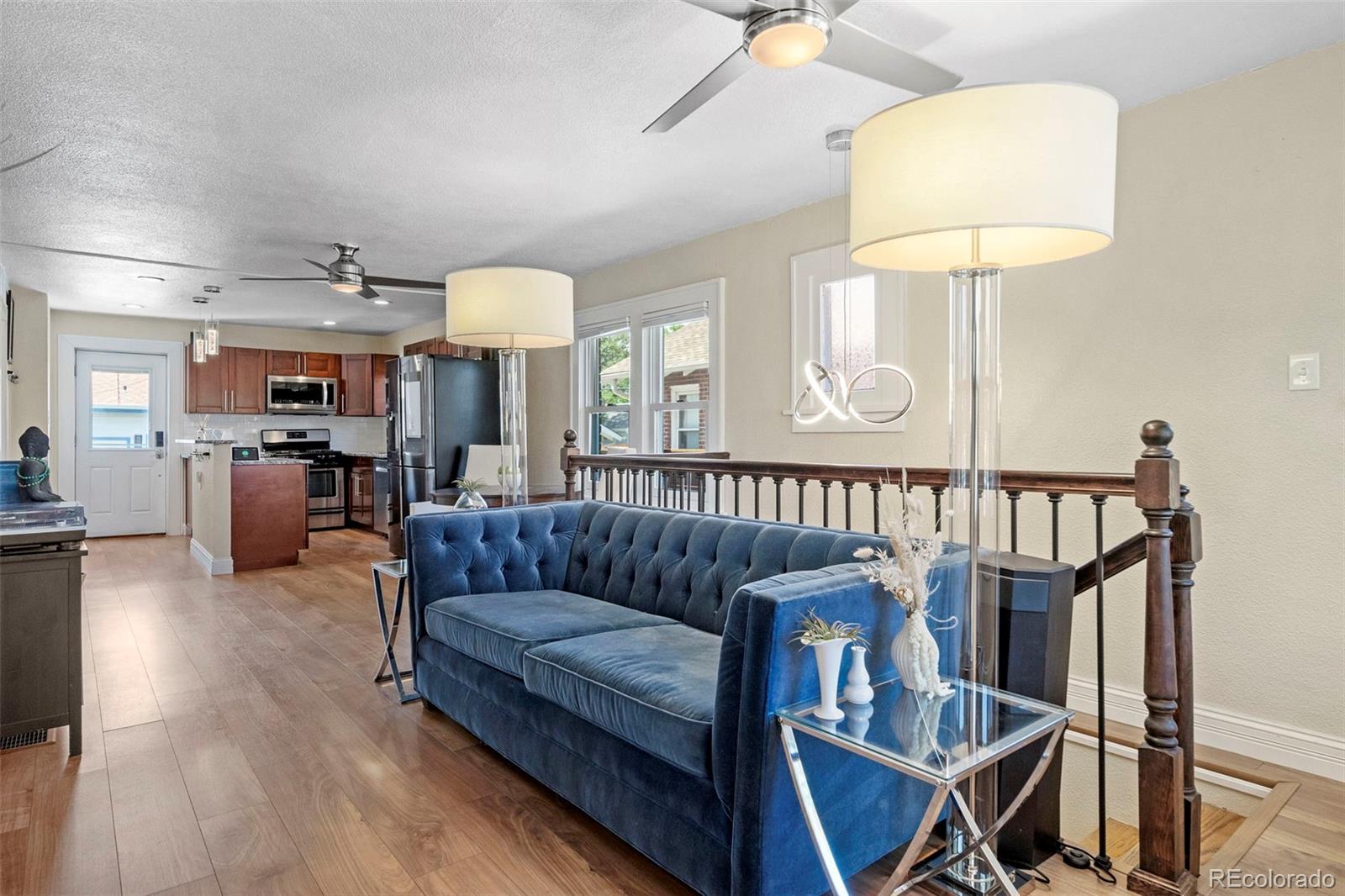 4319 Raritan Street Denver, CO 80211 - Photo 4 of 27 a living room with furniture and a chandelier