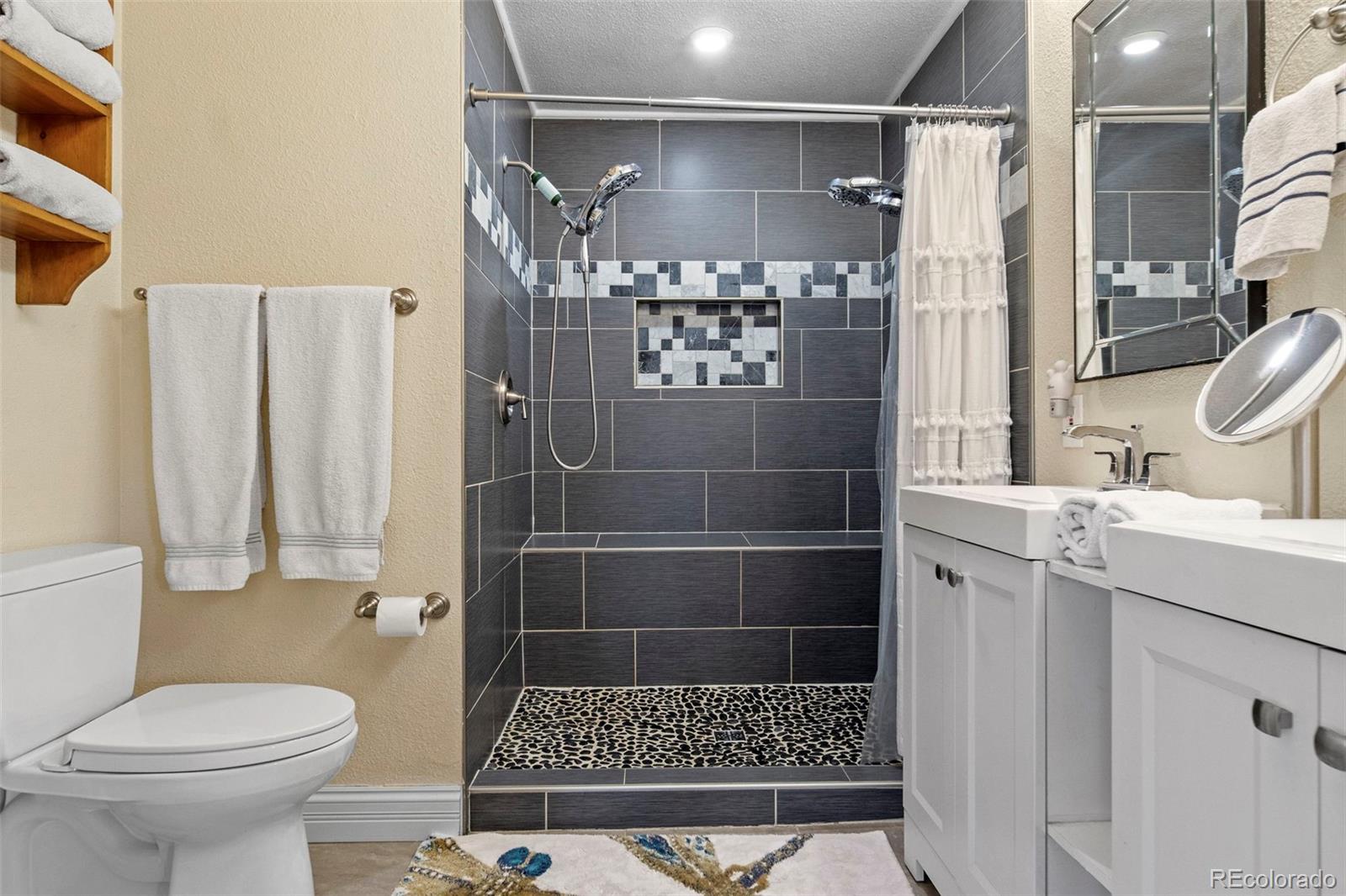 4319 Raritan Street Denver, CO 80211 - Photo 8 of 27 a bathroom with a toilet and a shower