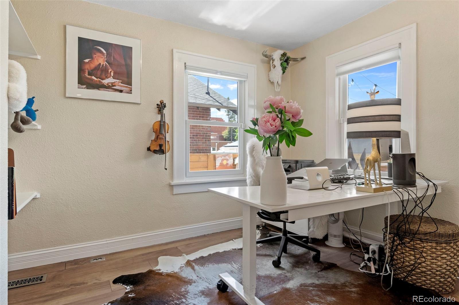 4319 Raritan Street Denver, CO 80211 - Photo 9 of 27 a view of a workspace with furniture and a potted plant