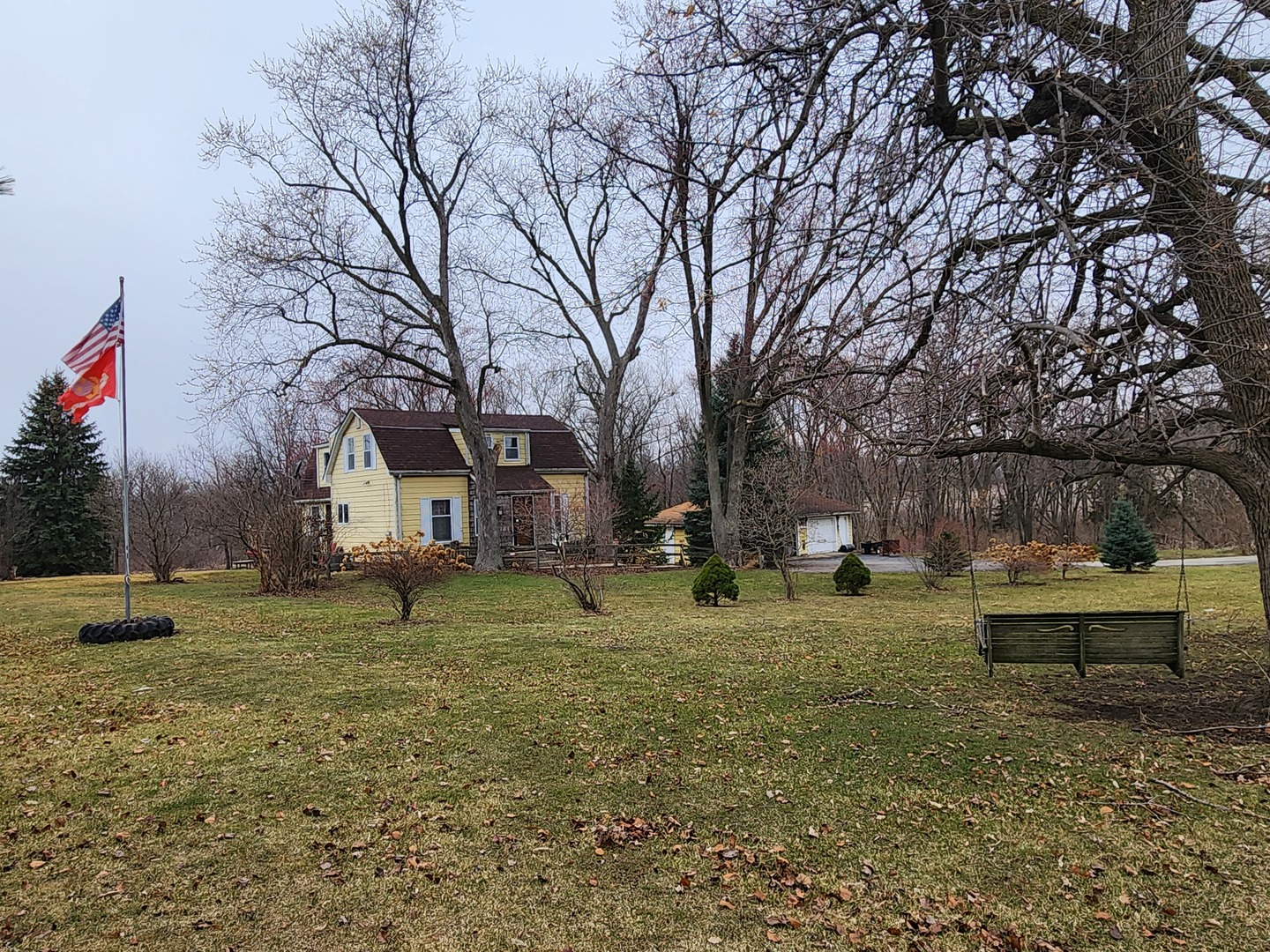 a backyard of a house with barbeque oven table and chairs