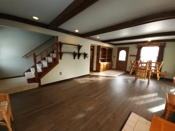 a bedroom with a bed chair and a window