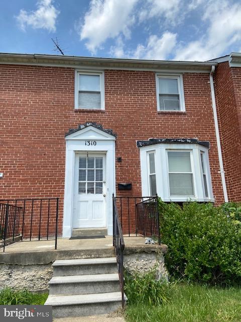 1310 Cedarcroft Road Baltimore, MD 21239 - Photo 1 of 22 All Brick Townhouse with front patio and bay windo
