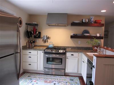 2 South Sandwich Road Sandwich, MA 02563 - Photo 2 of 17 a kitchen with stainless steel appliances granite countertop a stove a sink and a refrigerator