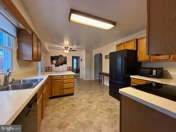 a kitchen with refrigerator and cabinets
