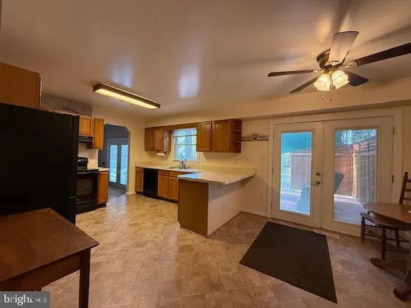 a large living room with stainless steel appliances granite countertop furniture a rug and a window