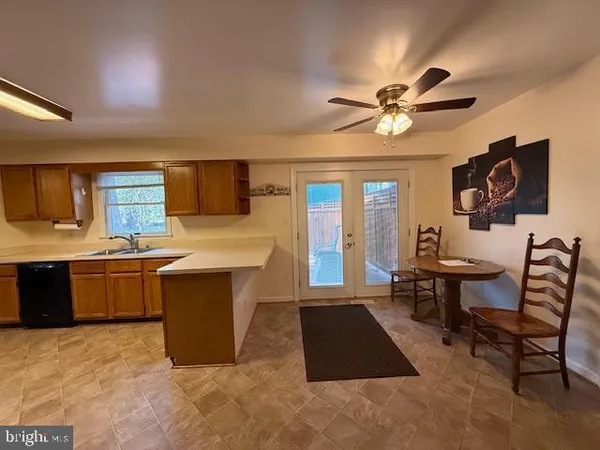 a spacious bathroom with a tub a sink and a chandelier
