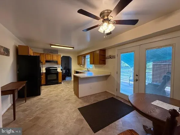 a kitchen with stainless steel appliances kitchen island granite countertop a refrigerator and a stove top oven