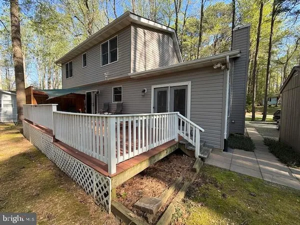 a view of a house with wooden fence
