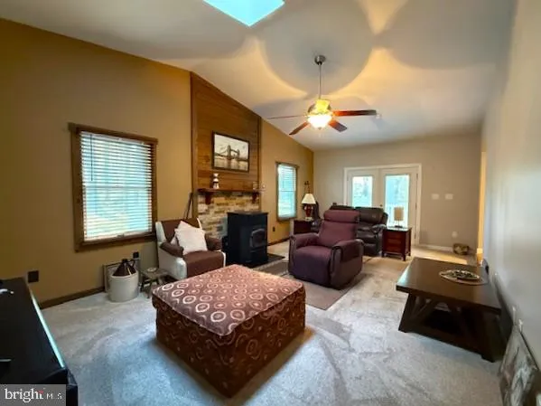 a living room with furniture ceiling fan and a window