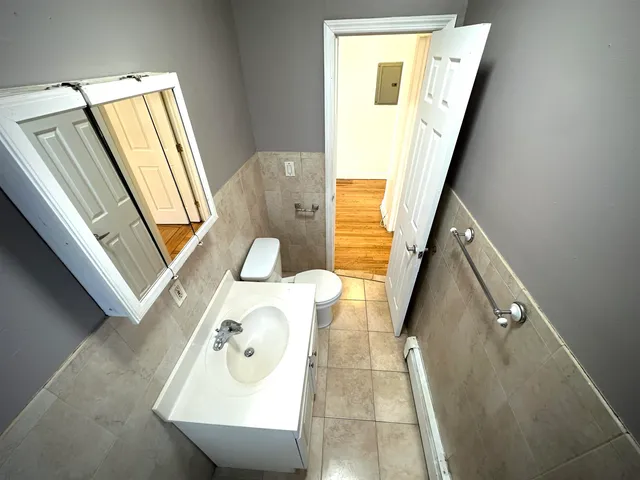 a bathroom with a sink a mirror and a window