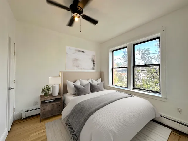 a bedroom with a bed and a window