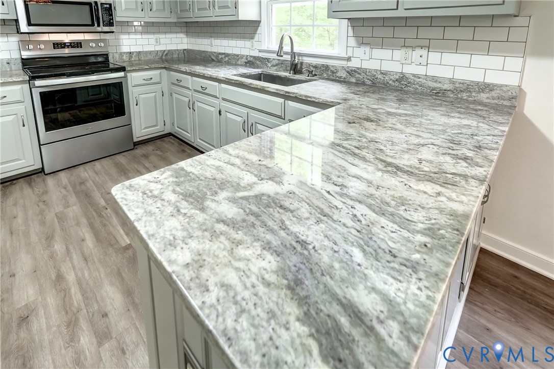 3820 Mt Pleasant Road Providence Forge, VA 23140 - Photo 5 of 40 a kitchen with granite countertop a sink and a stove