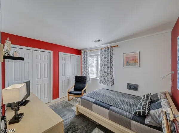 a bedroom with furniture and a window