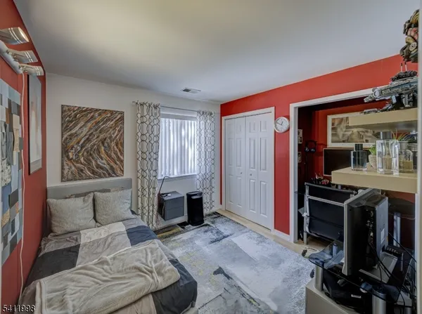 a bedroom with furniture and a window