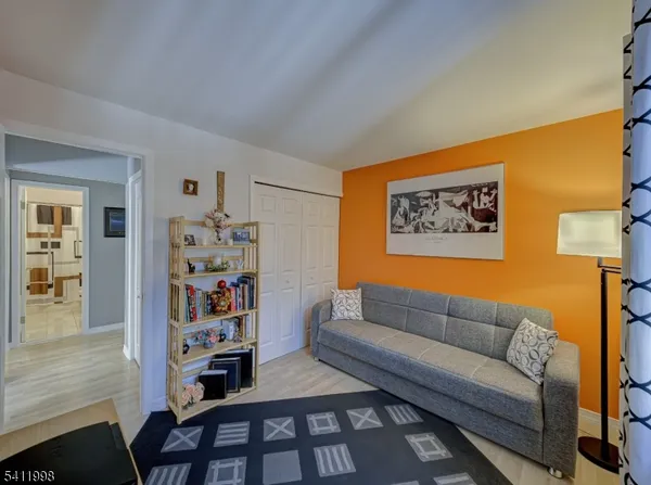 a living room with furniture and painting on the wall