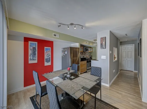 a view of a dining room with furniture and wooden floor