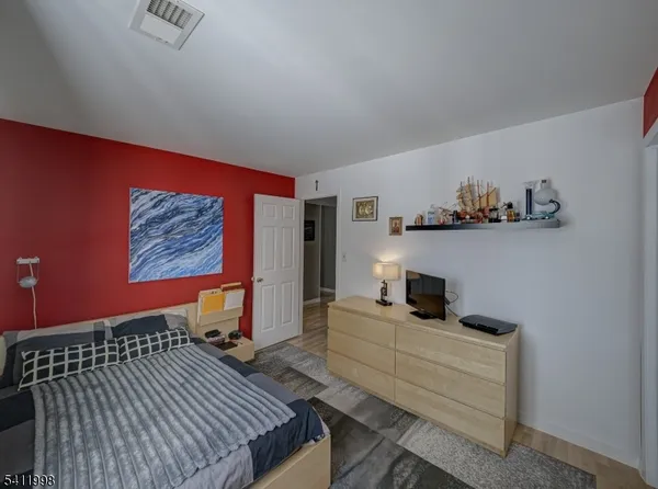 a bedroom with furniture and wooden floor