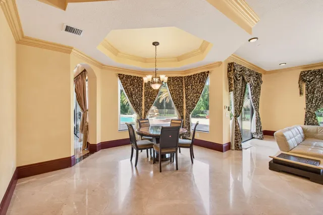 a kitchen with stainless steel appliances granite countertop a sink a stove and a wooden floors