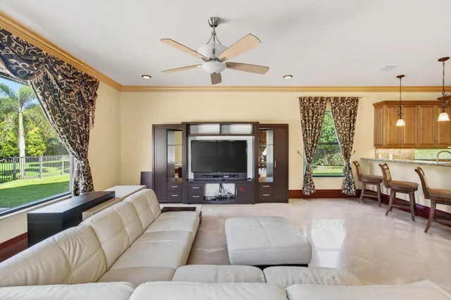 a view of a livingroom with furniture and a flat screen tv