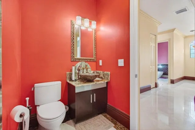 a front view of a building with a garden