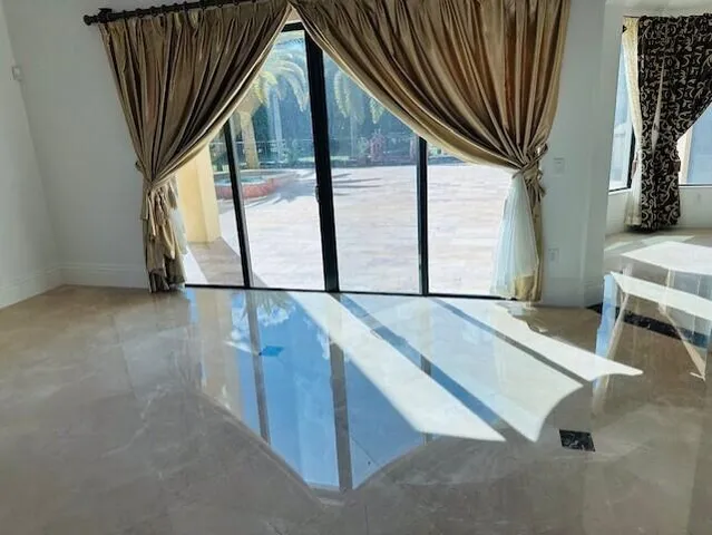 a large dining hall with stainless steel appliances kitchen island granite countertop furniture and a fireplace