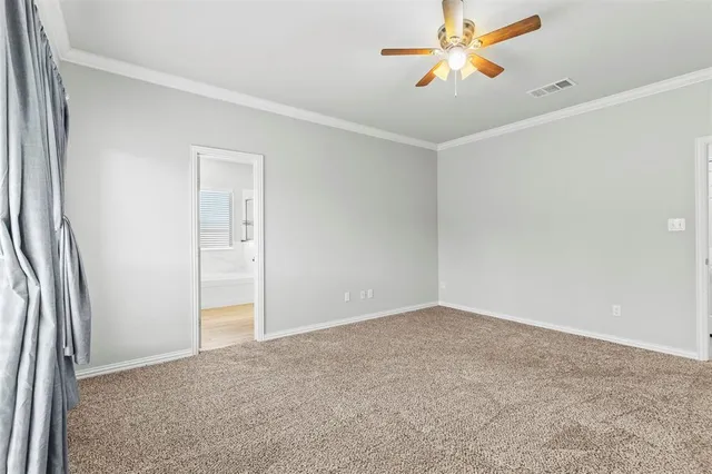 an empty room with closet and a chandelier fan