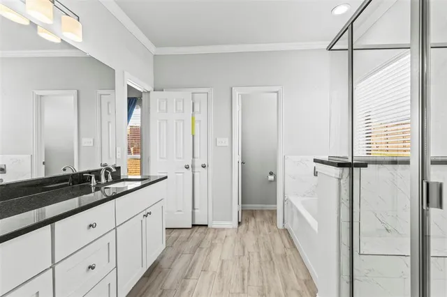 a bathroom with a double vanity sink and mirror with shower