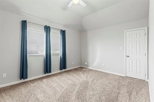 a view of an empty room with closet area