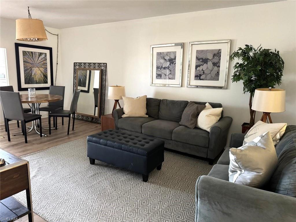 1900 Alamanda Drive, Unit 303 Naples, FL 34102 - Photo 4 of 12 a living room with furniture and a potted plant