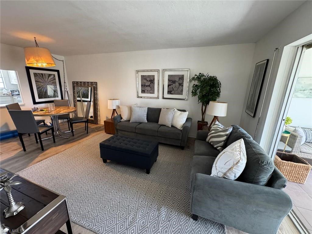 1900 Alamanda Drive, Unit 303 Naples, FL 34102 - Photo 5 of 12 a living room with furniture and a flat screen tv