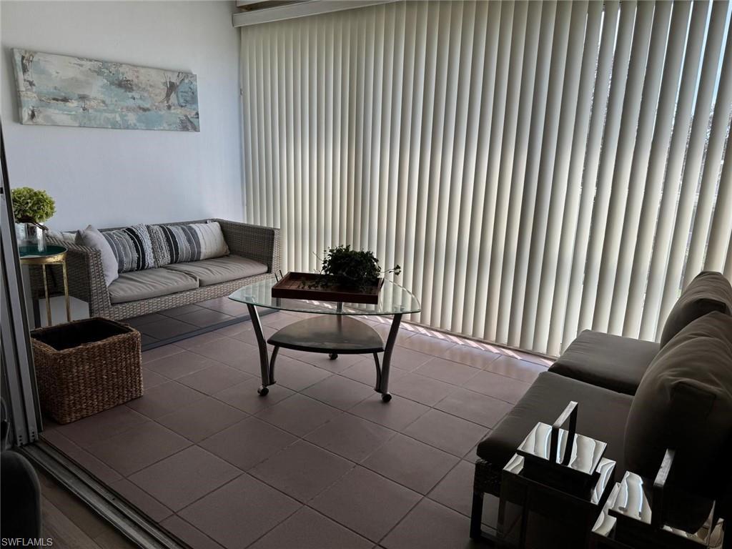 1900 Alamanda Drive, Unit 303 Naples, FL 34102 - Photo 6 of 12 a living room with furniture and a potted plant
